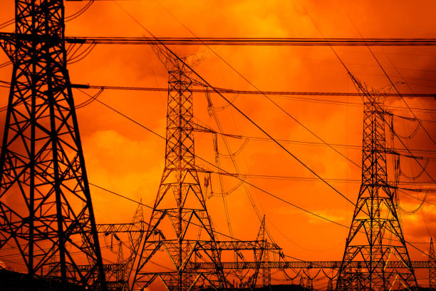 istock Electricity power lines over dramatic red stormy sky 1406415281