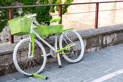 concrete parking for bicycles near an old brick house in the village