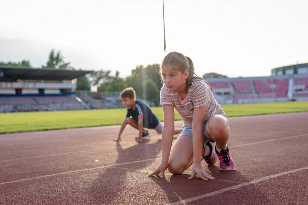 istock Kids preparing for track run race 1406418754