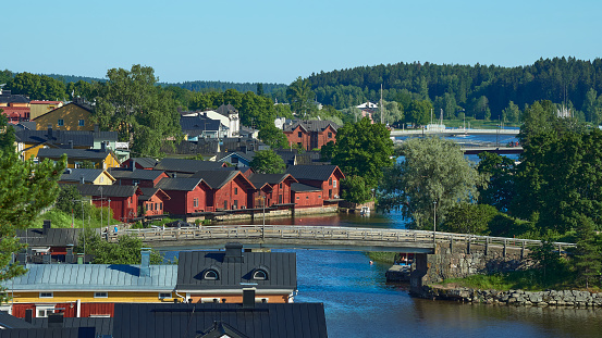 Panorama of old Finnish city of Porvoo: summer, sunny day, river, bridge, old red wooden houses.