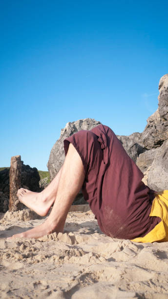 istock Crossed legs of man in a beach 1406420358