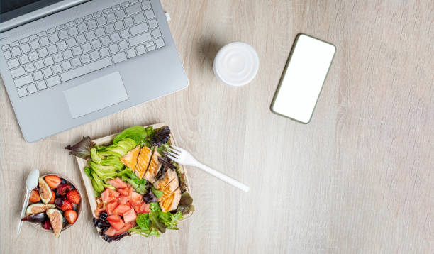 istock Workspace with laptop, healthy food takeaway 1406420544