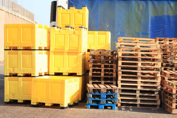 Wooden pallets and plastic containers stock photo