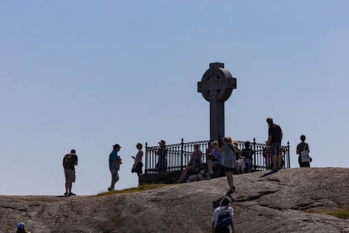 Birka, Sweden June 27, 2022 People viting the Ansgar memorial cross in memory of a Chrisitan missionary.