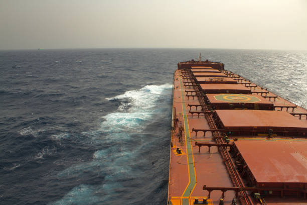 A merchant ship underway at sea in rough weather Merchant ship carrying bulk cargo is underway at sea in rough weather bulk carrier stock pictures, royalty-free photos & images