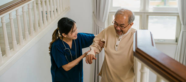 istock Nurse helping the elderly walk up the stairs 1406446188