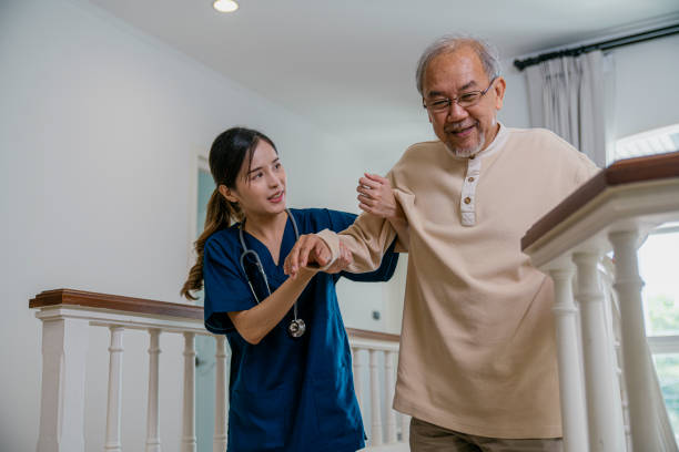 istock Nurse helping the elderly walk up the stairs 1406446290