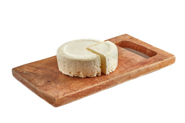 Fresh panela cheese made in Mexico on old rustic wooden board.