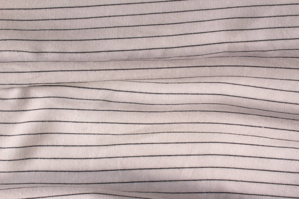 istock White crumpled fabric linen with black stripe for creative background. Copy space. Natural textile for wallpaper or design 1406450933