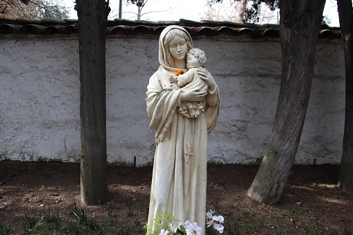 Virgin Mary with the baby Jesus in her arms in a garden in Santiago, Chile