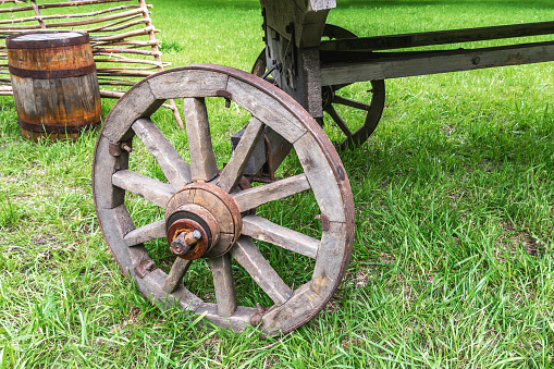 Old wooden cart wheel close-up. Rural ancient means of transportation