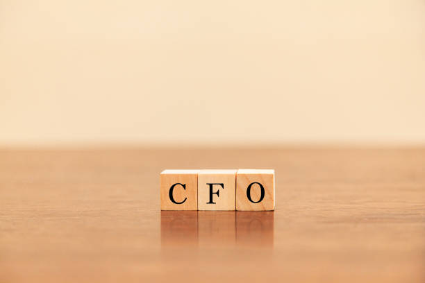 CFO character. CFO. Chief Financial Officer. Written on three wooden blocks. Black letters. CFO character. CFO. Chief Financial Officer. Written on three wooden blocks. Black letters. Wooden table and white wallpaper background. cfo stock pictures, royalty-free photos & images