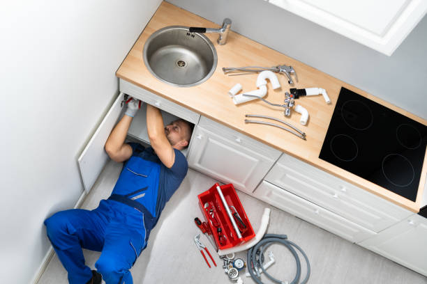 istock Male Plumber Fixing Sink Pipe 1406459134