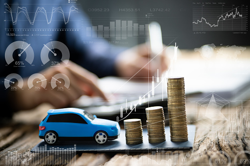 Blue Toy Car In Front Of Businessman Calculating Loan