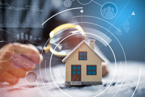 istock Businessman Holding Magnifying Glass Over House Model 1406459260