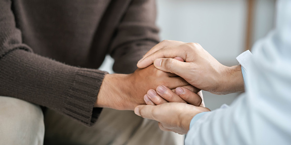 Male doctors shake hands with patients encouraging each other and praying for blessings. To offer love, concern, and encouragement while checking the patient's health. concept of medicine and health care