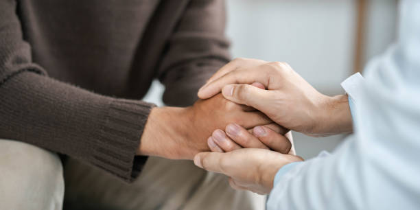 Male doctors shake hands with patients encouraging each other and praying for blessings. To offer love, concern, and encouragement while checking the patient's health. concept of medicine and health care Male doctors shake hands with patients encouraging each other and praying for blessings. To offer love, concern, and encouragement while checking the patient's health. concept of medicine and health care grief stock pictures, royalty-free photos & images