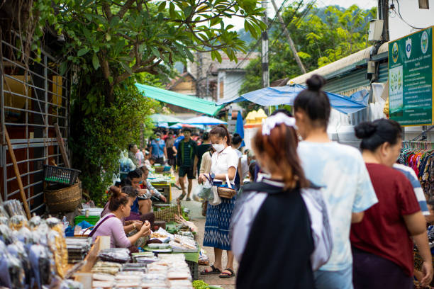 Local people Selling fresh vegetables and foods  at the morning market. Luang Prabang, Laos - June 19 2022: Local people selling fresh vegetables and foods  at the morning market in Luang Prabang, Laos historic heritage square phoenix stock pictures, royalty-free photos & images