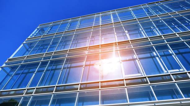 istock Modern office building with glass facade on a clear sky background. 1406459825