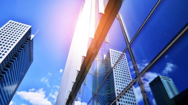 istock Modern office building with glass facade on a clear sky background. 1406460453