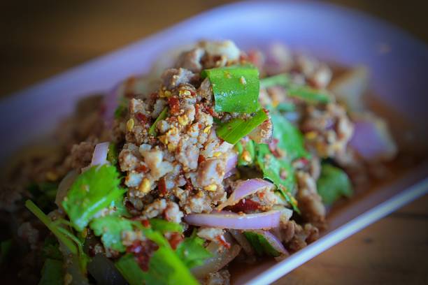 istock Thai food, spicy minced pork salad (Larb Moo) on white dish 1406465682