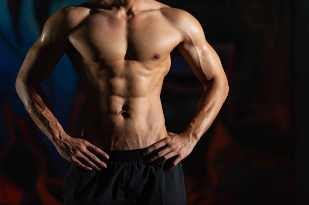 Portrait of Shirtless Asian man bodybuilder do sport training workout in abandoned building. Portrait of Shirtless strong Asian sportsman athlete do sport training workout exercise bodybuilding in abandoned building. Active man bodybuilder practicing muscular strength training in dark old gym boxercise stock pictures, royalty-free photos & images