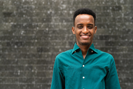 Portrait of handsome young black man outdoors in city