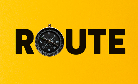 Route word with compass on yellow \n background.