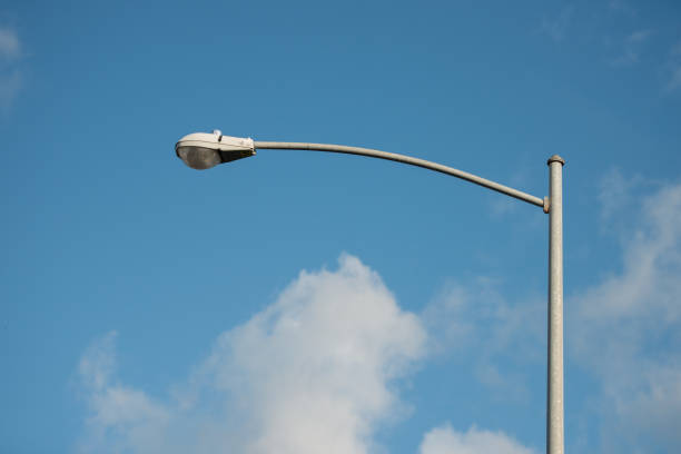 street lamp post with blue sky and white clouds - street post imagens e fotografias de stock