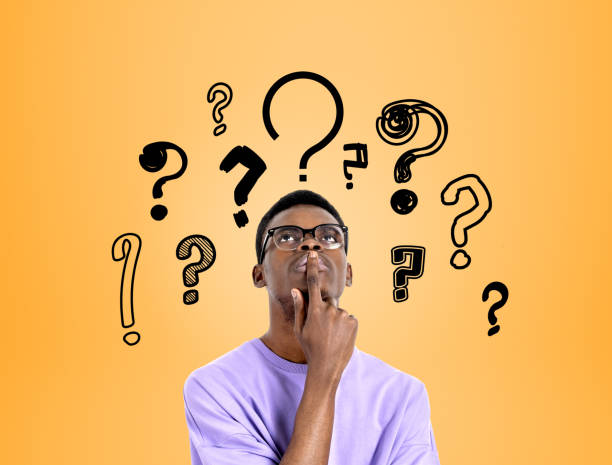 istock Young black man with pensive look, set of question marks on brig 1406475399