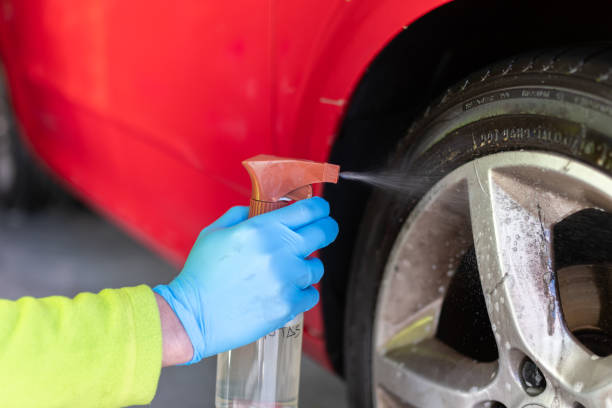 istock hand with blue glove doing wheel cleaning with spray liquid 1406475532