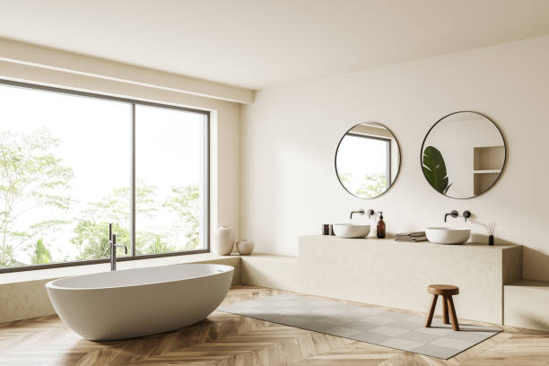 istock Light bathroom interior with bathtub and sink, accessories and panoramic window 1406476440