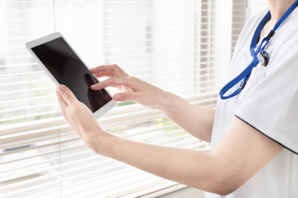 istock A nurse or doctor who inputs and manages information on a tablet 1406477525