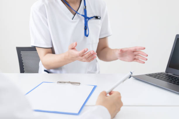 A nurse working in a hospital explaining how to write a document stock photo