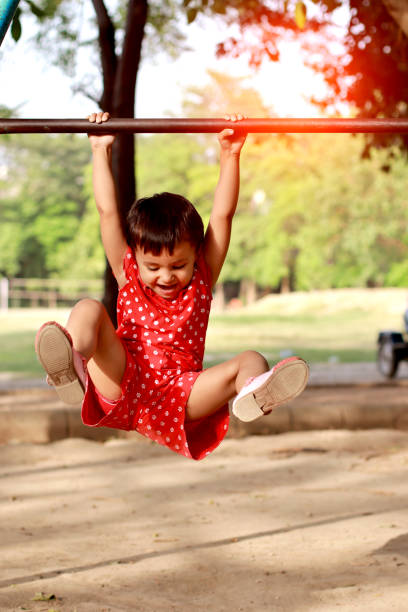 istock Excited little girl playing in park 1406478252