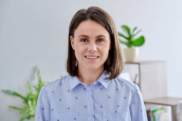 istock Headshot young smiling woman looking at camera in home interior 1406485393