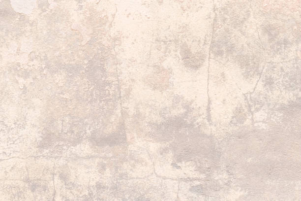 Beige beton texture, light brown concrete background, cement wall surface. Stucco, plaster. Blank space. Backdrop design. Natural grunge wallpaper, weathered old paper. Pastel color table with cracks. stock photo