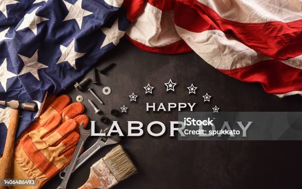 Happy Labor Day Concept American Flag With Different Construction Tools And The Text On Dark Stone Background Stock Photo - Download Image Now