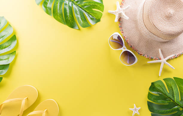 istock Summer composition concept made from starfish, beach hat, flip flop and monstera leaf on pastel yellow background. 1406486533