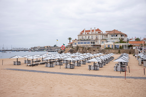 Beach in the City of Cascais in Portugal in Summer with cloudy sky in the day.