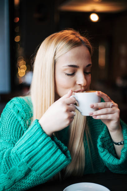 Pretty blonde woman in a cafe.
