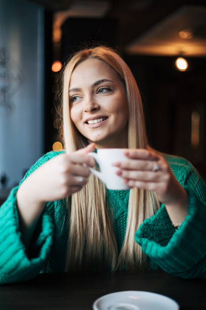 Pretty blonde woman in a cafe.