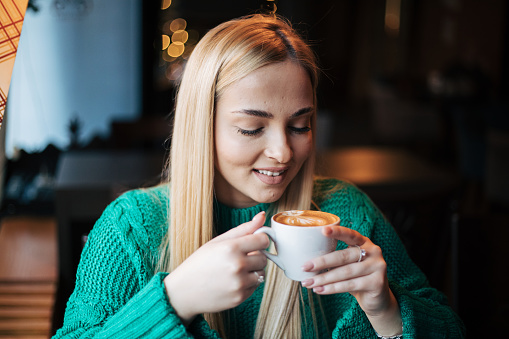 Pretty blonde woman in a cafe.