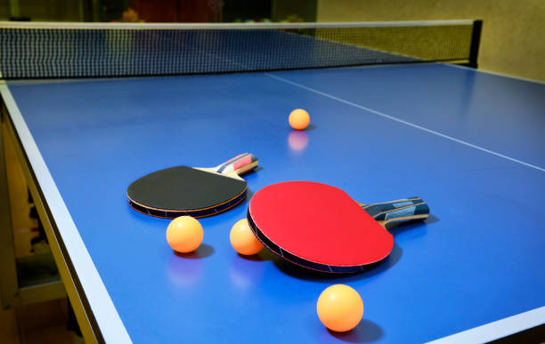 istock Ping pong, table tennis, racket  with orange ping pong balls on blue table. 1406489834