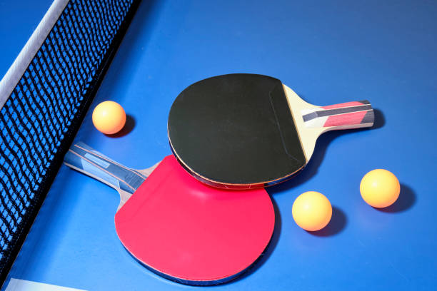 istock Ping pong, table tennis, racket  with orange ping pong balls on blue table. 1406489837