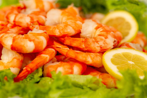 istock Appetizing dish with boiled shrimp, lettuce and lemon. 1406489870