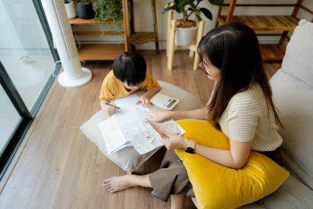 istock Asian Mother Using Laptop To Check Finances At Home 1406492532