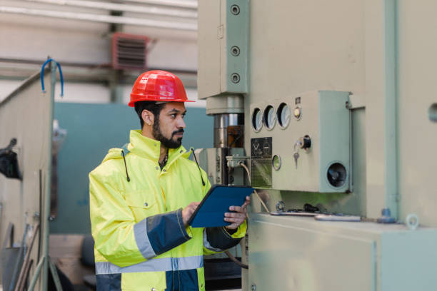 istock Portrait of engineer male using tablet while checking machines in industrial factory. 1406492868