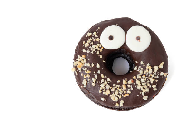 istock Tasty chocolate donut with eyes and nuts isolated on white background with soft shadow 1406493960