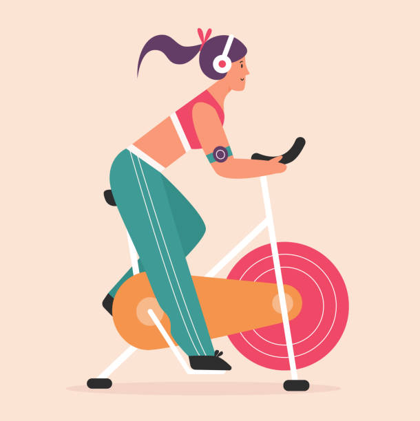 junge frau radfahren auf dem heimtrainer im fitnessstudio des sportvereins oder zu hause, indoor-training - spinning-bike stock-grafiken, -clipart, -cartoons und -symbole